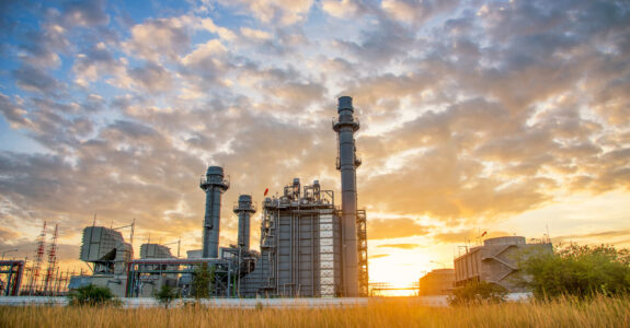 Turbine electric power plant building during sunset time on nature background