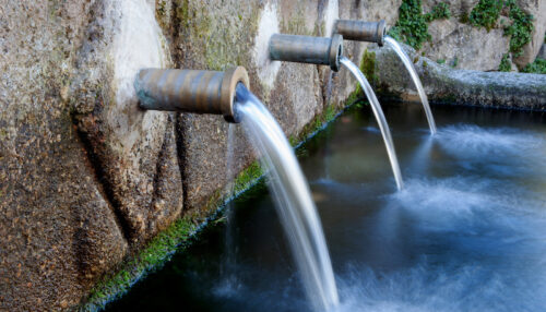 Source of three pipes with crystal clear water