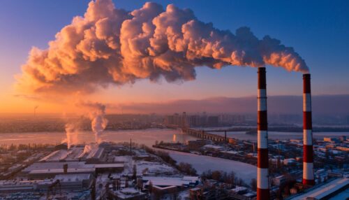 Plant pipe high above the clouds. Harmful emissions into the upper atmosphere.