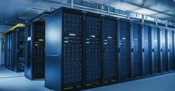 Shot of Modern Data Center With Multiple Rows of Operational Server Racks. Modern High-Tech Database Super Computer Clean Room.