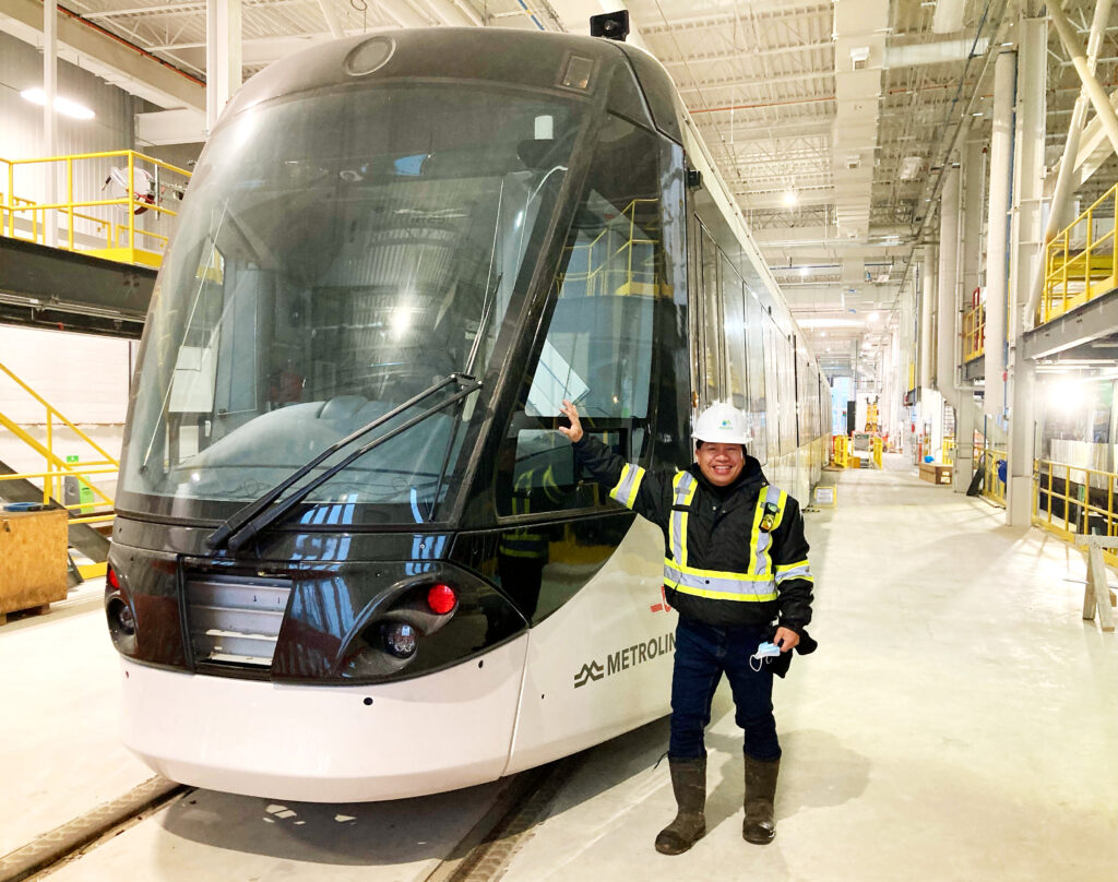 The train has arrived Montrose’s Arnie Fausto poses with a new light rail vehicle during construction of the Finch West LRT project in Toronto, Canada.