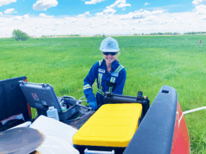 2021 - Angela Eberhard conducting low flow sampling near Wainwright, AB_Montrose Logos